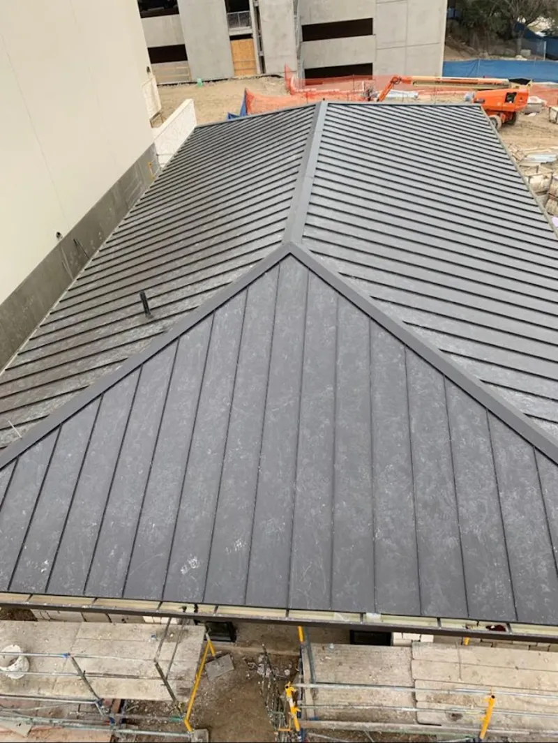 Commercial metal roof construction with crane equipment in Lawrenceburg